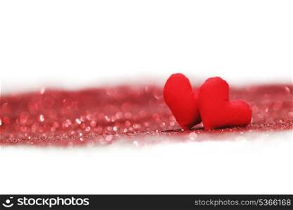 Valentines day decorative hearts on red glitter background
