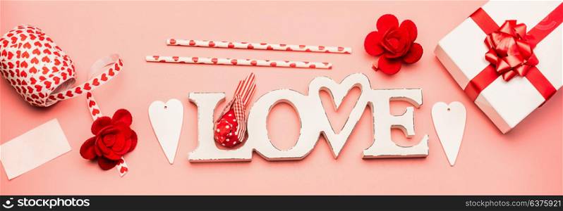 Valentines day flat lay banner with word Love , gift box, hearts and decoration, top view. Love and romantic concept