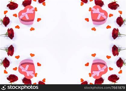 Valentines day frame of hearts, red rose flowers and gift box isolated on white background. Valentines day gifts and flowers