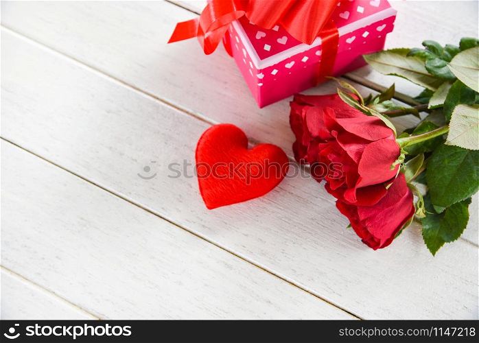 Valentines day gift box pink on white table background / Romantic red heart valentines red roses flower and present box ribbon bow - Love concept