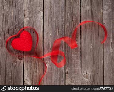 Valentines day heart shaped ribbon on wooden table. Top view with copy space