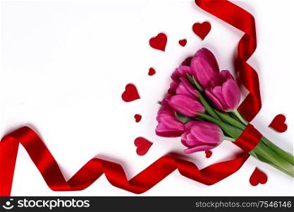 Valentines day hearts and pink tulip flowers isolated on white background. Tulip flowers and hearts on white