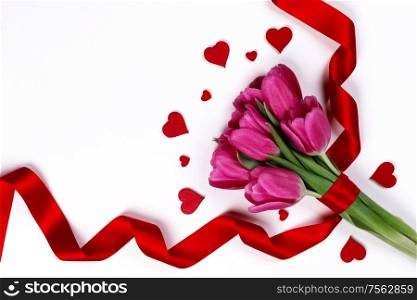 Valentines day hearts and pink tulip flowers isolated on white background. Tulip flowers and hearts on white