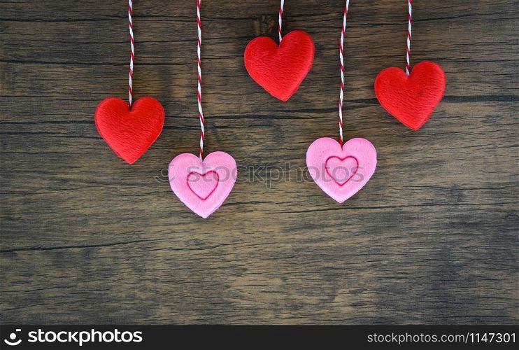 Valentines day love heart concept / Hanging red and pink heart decorate on wooden rustic texture background