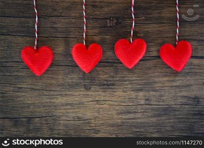 Valentines day love heart concept / Hanging red heart decorate on wooden rustic texture background