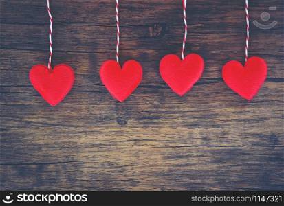 Valentines day love heart concept / Hanging red heart decorate on wooden rustic texture background