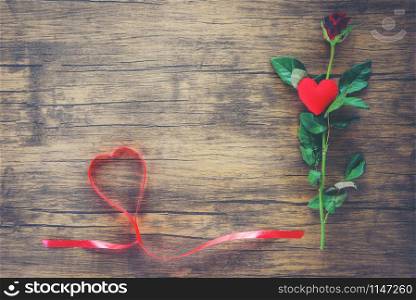 Valentines day red rose flower on wooden background / Red heart with roses and red ribbon heart on top view copy space