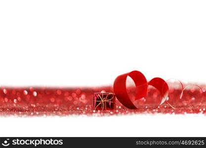 Valentines day ribbon heart and gift on decorative glitters, isolated on white