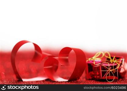Valentines day ribbon hearts and gifts on decorative glitters, isolated on white