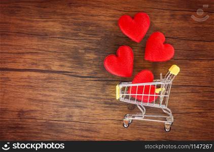 Valentines day shopping and red heart on shopping cart love concept / Shopping holiday for love Valentines day on wooden background tone vintage style top view copy space - Shopping vacation