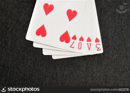 Valentines day. The word love spelled with playing cards