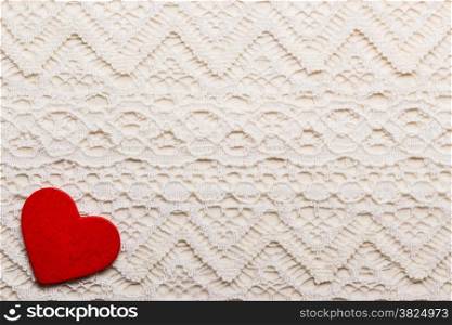 Valentines day wedding, invitation or greeting card. Red decorative heart love symbol on white cloth lace background