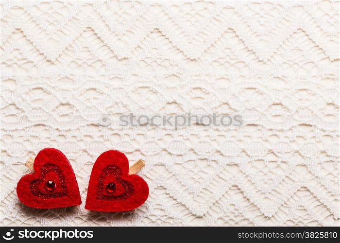 Valentines day wedding, invitation or greeting card. Red decorative hearts love symbol on white cloth lace background