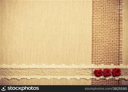 Valentines day, wedding, invitation or greeting card. Red decorative silk rose flowers, lace ribbon on linen cloth. Border frame. Retro style