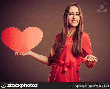Valentines Day. Woman holding heart sign love symbol studio shot. Vintage retro photo.