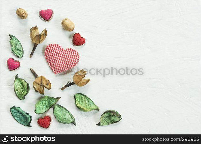 Valentines, love and wedding background concept. Red heart with decorated things on white wood texture table. Picture for add text message. Backdrop for design art work.