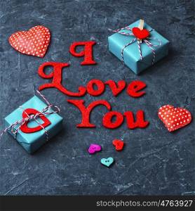 Valentines wrapped gift on slate backgrounds with the inscription I love you. Gift boxes with ribbons