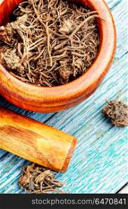 Valerian herb root. Traditional folk remedy from valerian roots in a mortar
