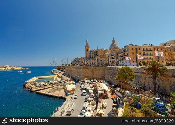 Valletta. City embankment on a sunny day.. The Basilica of Our Lady of Mount Caramel in the historical part of Valletta. Malta.