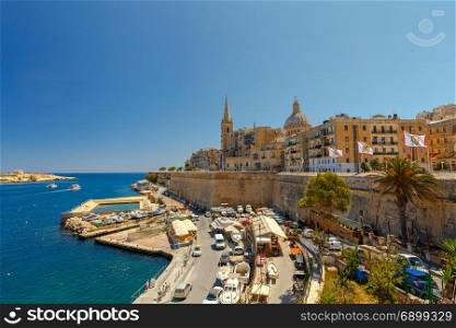 Valletta. City embankment on a sunny day.. The Basilica of Our Lady of Mount Caramel in the historical part of Valletta. Malta.
