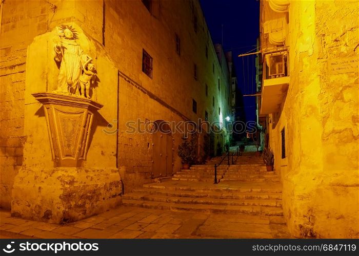 Valletta. Old medieval street at night.. Narrow traditional medieval street in Valletta at night. Malta.