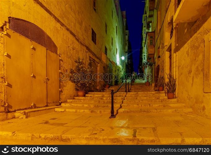 Valletta. Old medieval street at night.. Narrow traditional medieval street in Valletta at night. Malta.