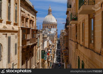 Valletta. Old medieval street.. Statue of the patron saint on medieval street in Valletta. Malta.