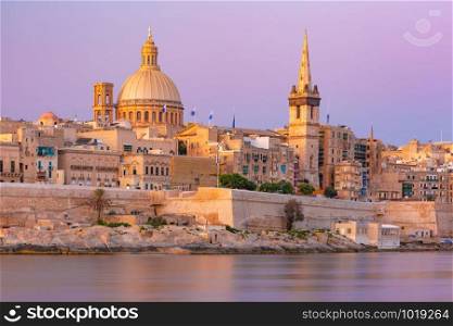 Valletta Skyline at beautiful sunset from Sliema with churches of Our Lady of Mount Carmel and St. Paul&rsquo;s Anglican Pro-Cathedral, Valletta, Capital city of Malta. Valletta Skyline from Sliema at sunset, Malta