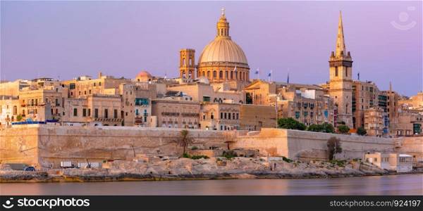 Valletta Skyline at beautiful sunset from Sliema with churches of Our Lady of Mount Carmel and St. Paul's Anglican Pro-Cathedral, Valletta, Capital city of Malta. Valletta Skyline from Sliema at sunset, Malta