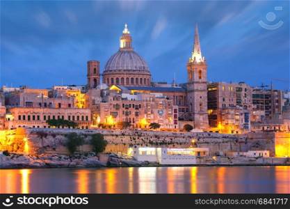 Valletta Skyline from Sliema at night, Malta. Valletta Skyline from Sliema with church of Our Lady of Mount Carmel and St. Paul&rsquo;s Anglican Pro-Cathedral during evening blue hour, Valletta, Capital city of Malta