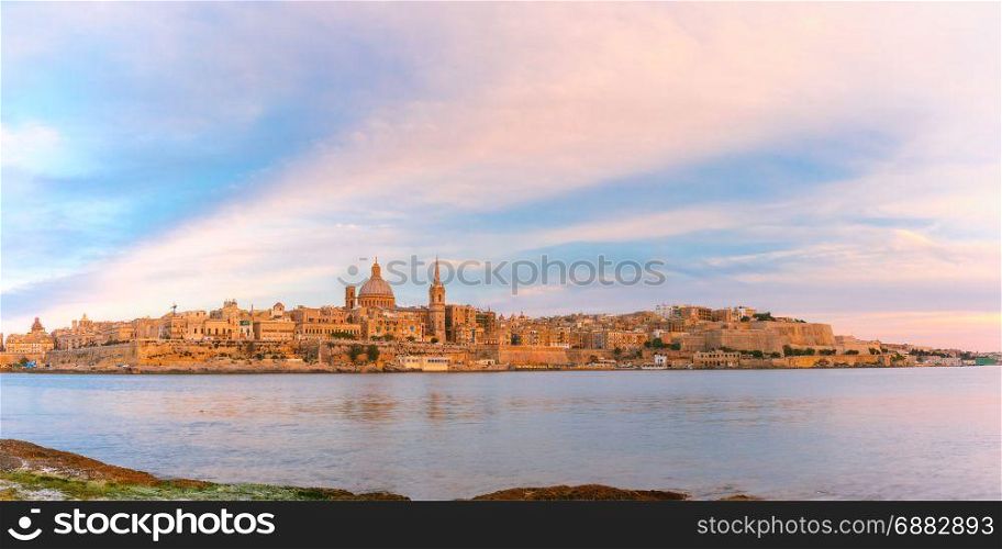 Valletta Skyline from Sliema at sunset, Malta. Panoramic view of Valletta Skyline at beautiful sunset from Sliema with churches of Our Lady of Mount Carmel and St. Paul&rsquo;s Anglican Pro-Cathedral, Valletta, Capital city of Malta