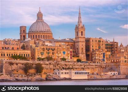 Valletta Skyline from Sliema at sunset, Malta. Valletta Skyline with ship at beautiful sunset from Sliema with churches of Our Lady of Mount Carmel and St. Paul&rsquo;s Anglican Pro-Cathedral, Valletta, Capital city of Malta