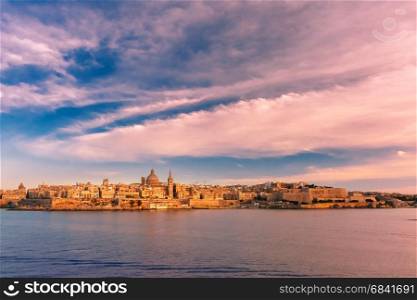 Valletta Skyline from Sliema at sunset, Malta. Valletta Skylineat at beautiful sunset from Sliema with churches of Our Lady of Mount Carmel and St. Paul&rsquo;s Anglican Pro-Cathedral, Valletta, Capital city of Malta