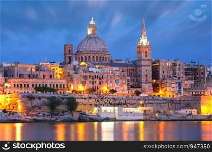 Valletta Skyline from Sliema with church of Our Lady of Mount Carmel and St. Paul's Anglican Pro-Cathedral during evening blue hour, Valletta, Capital city of Malta. Valletta Skyline from Sliema at night, Malta