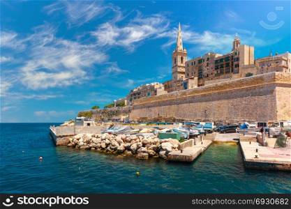 Valletta Skyline in sunny day, Malta. Valletta Skyline with fortress wall, boat pier and St. Paul&rsquo;s Anglican Pro-Cathedral, Valletta, Capital city of Malta. View from the sea