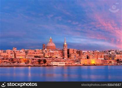Valletta Skylineat at beautiful sunset from Sliema with churches of Our Lady of Mount Carmel and St. Paul&rsquo;s Anglican Pro-Cathedral, Valletta, Capital city of Malta. Valletta Skyline from Sliema at sunset, Malta