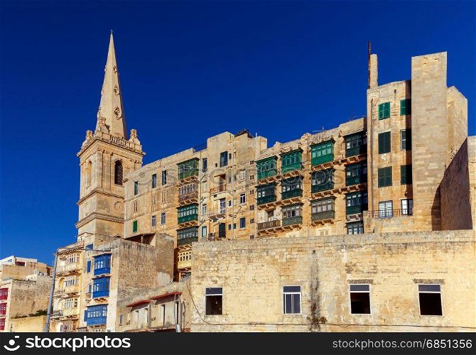 Valletta. Traditional architecture of the city.. Ancient stone medieval buildings in Valletta. Malta.