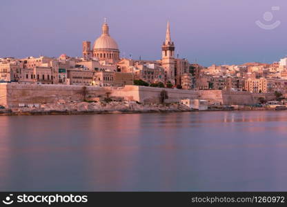 Valletta with Our Lady of Mount Carmel church and St. Paul&rsquo;s Anglican Pro-Cathedral at sunrise as seen from Sliema, Valletta, Malta. Valletta Skyline from Sliema at sunset, Malta