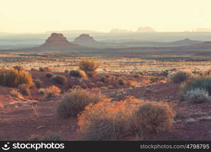 Valley of the Gods rock formation with Monument Valley at sunrise