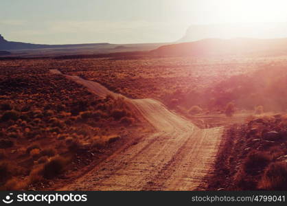 Valley of the Gods rock formation with Monument Valley at sunrise