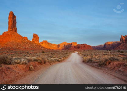 Valley of the Gods rock formation with Monument Valley at sunrise