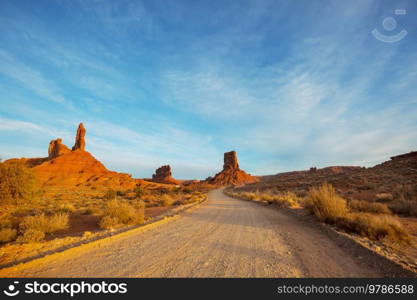 Valley of the Gods rock formation with Monument Valley at sunrise