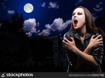 Vampire girl on night sky with moon