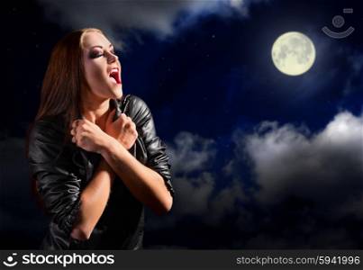 Vampire girl on night sky with moon