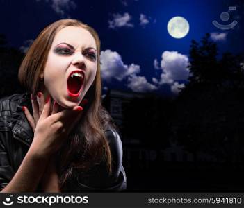 Vampire woman on night background with moon
