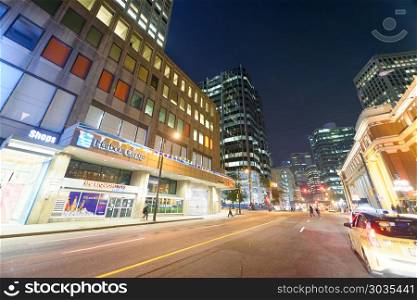 VANCOUVER, CANADA - AUGUST 8, 2017: Streets of Downtown with tou. VANCOUVER, CANADA - AUGUST 8, 2017: Streets of Downtown with tourists at night. Vancouver attracts 10 million people annually.