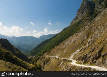 Vandelli Way. Ancient road in the valley below a cliff