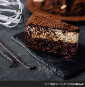 Vanilla and chocolate cake on black board