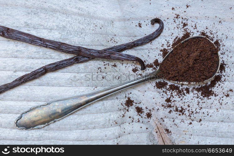 Vanilla and vanilla beans on a spoon macro.. Vanilla and vanilla beans on a spoon macro