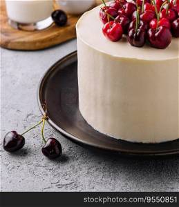 vanilla cheesecake mousse with cherries on black plate